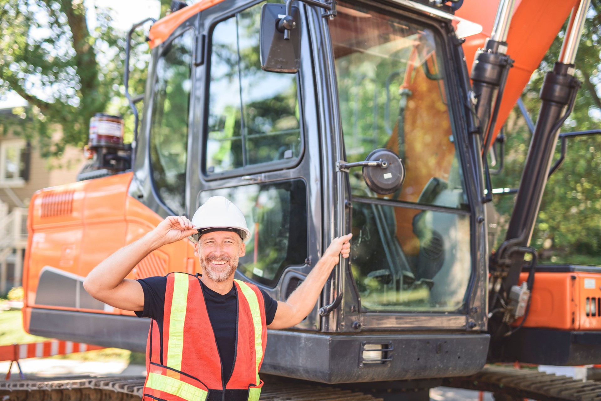 caucasian engineer with white helmet at work and having a mechanical shovel on the back